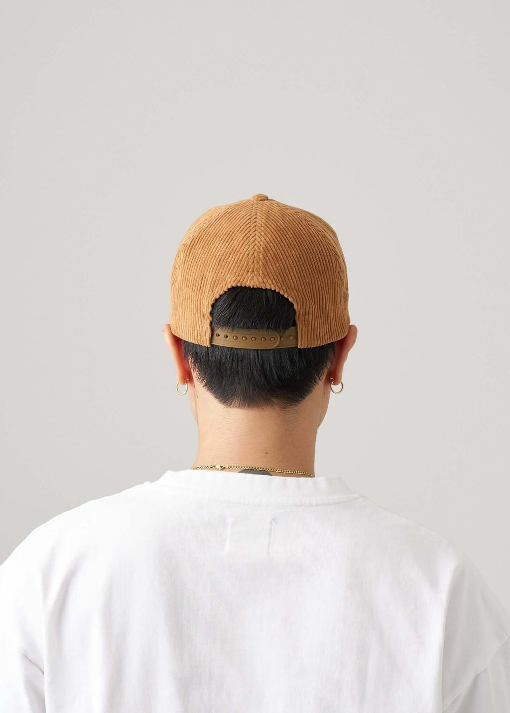 corduroy snapback hat in amber ash back view on model