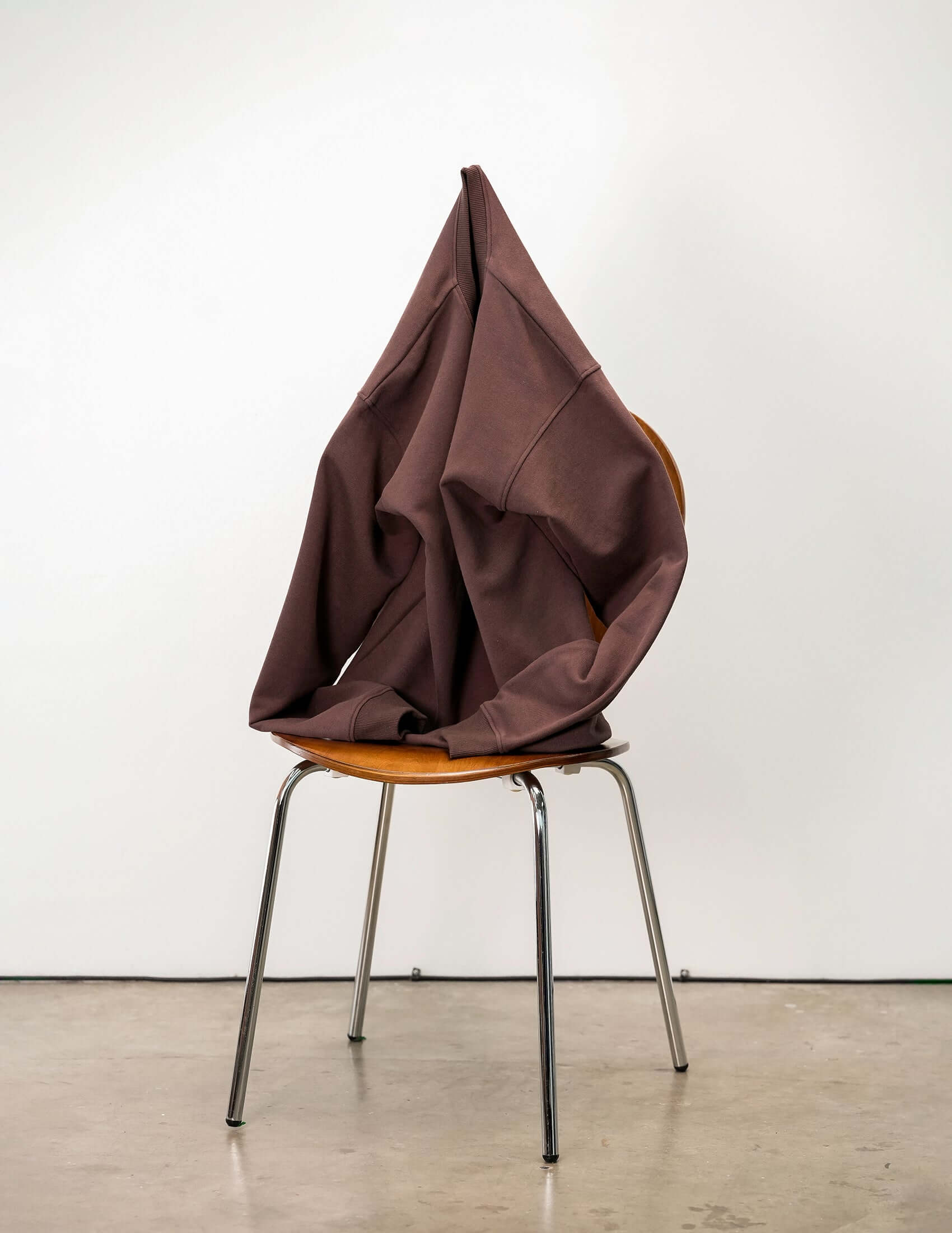 French Terry crewneck sweatshirt draped over a chair, showcasing its soft texture and stylish design.