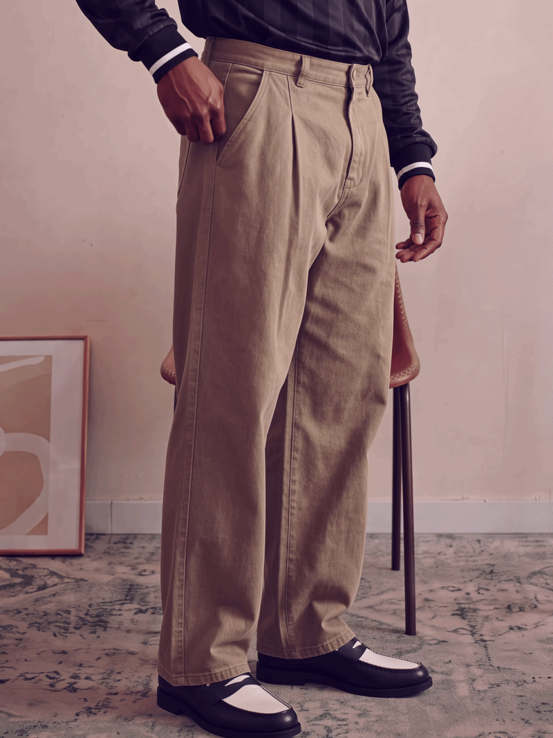Men's khaki pleated trousers featuring a relaxed fit and structured cotton twill material.