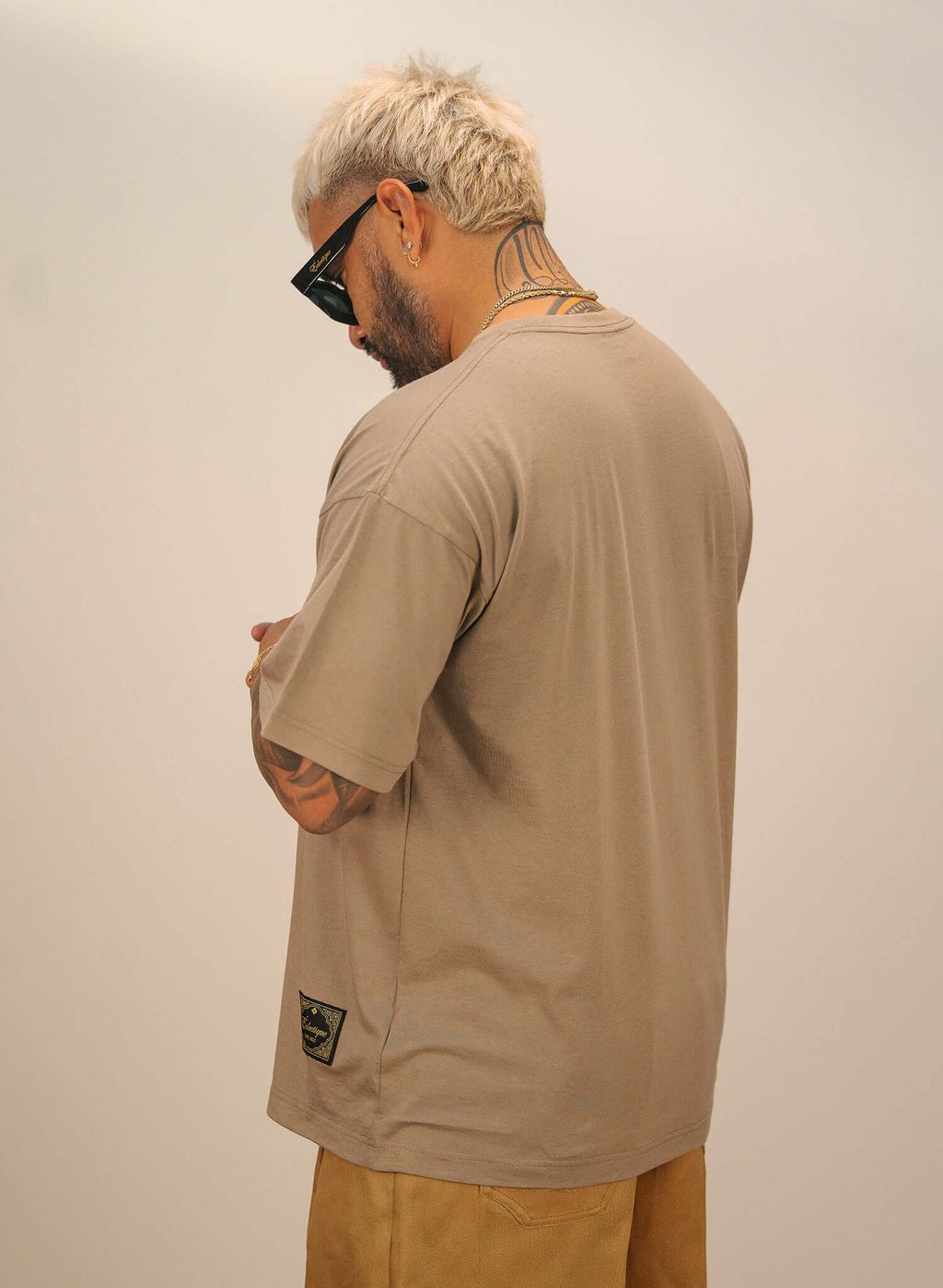 Men's sand cotton t-shirt worn from the back, showcasing relaxed fit and crew neckline.