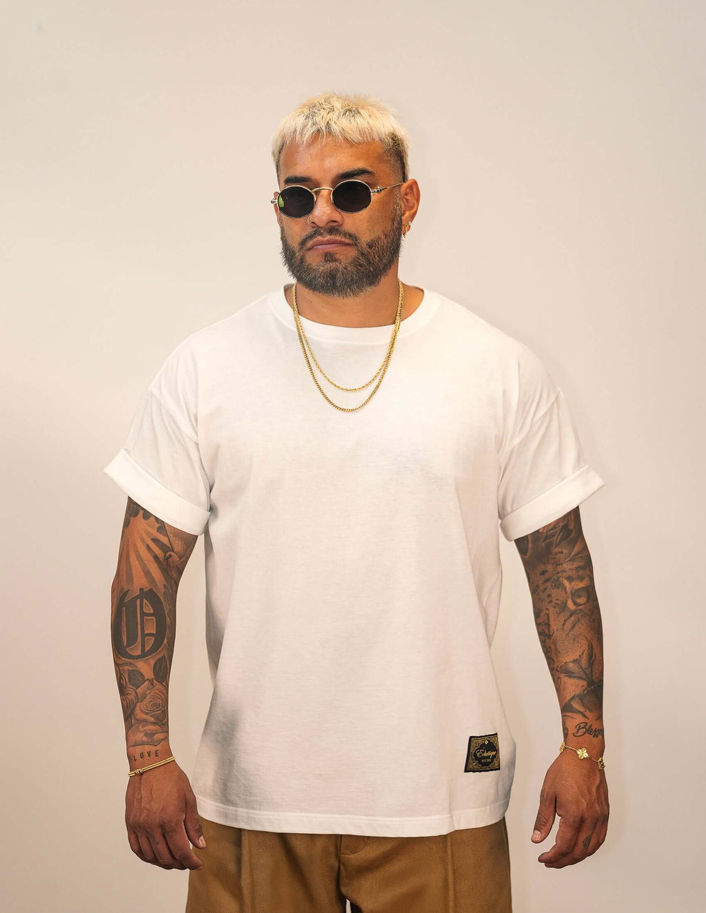 Men's White Cotton T-shirt modeled by a man wearing sunglasses and jewelry, showcasing a relaxed fit.