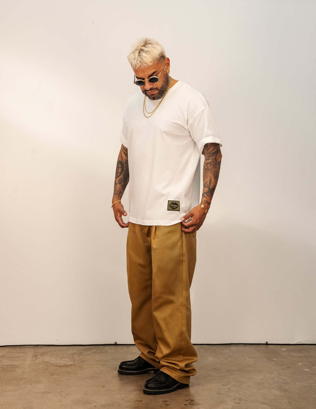Men's White Cotton T-shirt worn with relaxed fit pants, showcasing a casual everyday style.