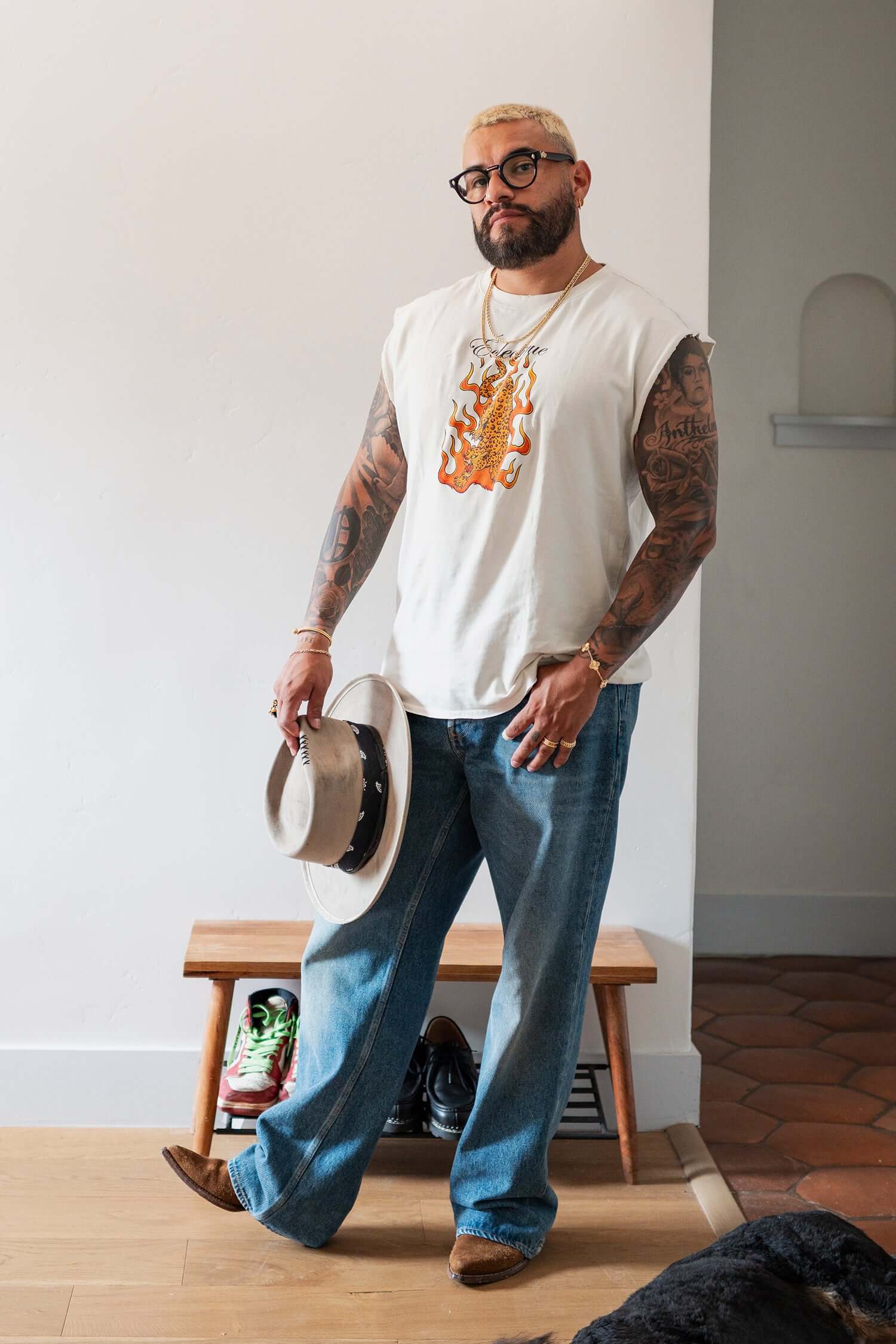 Man wearing a Jaguar Graphic T-shirt with flaming artwork, styled with jeans and a hat, showcasing a modern look.