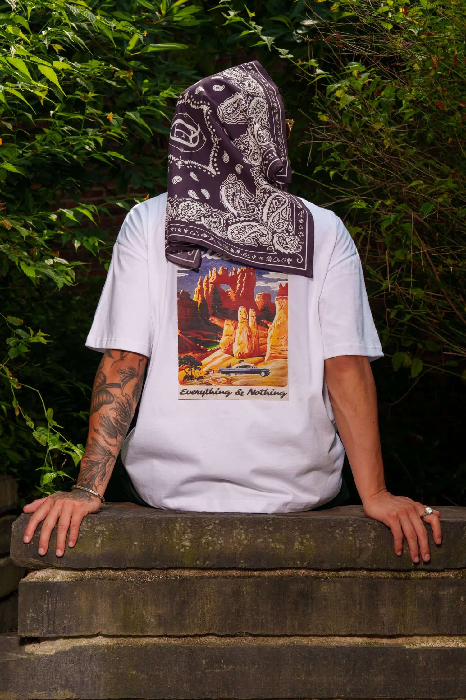 Sedona graphic T-shirt back view with desert poster artwork worn outdoors