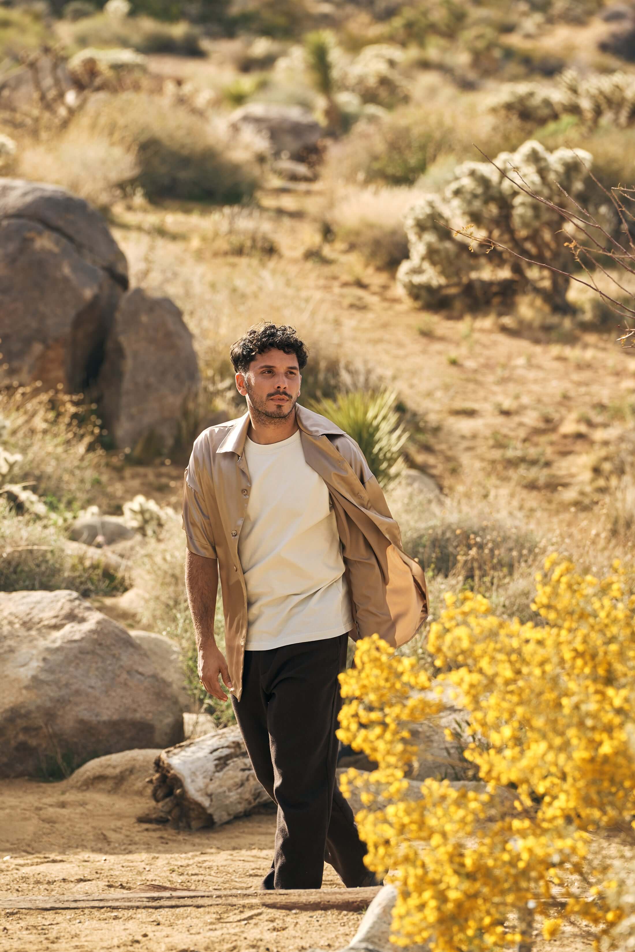 model wearing beige silk bowling shirt styled outdoors