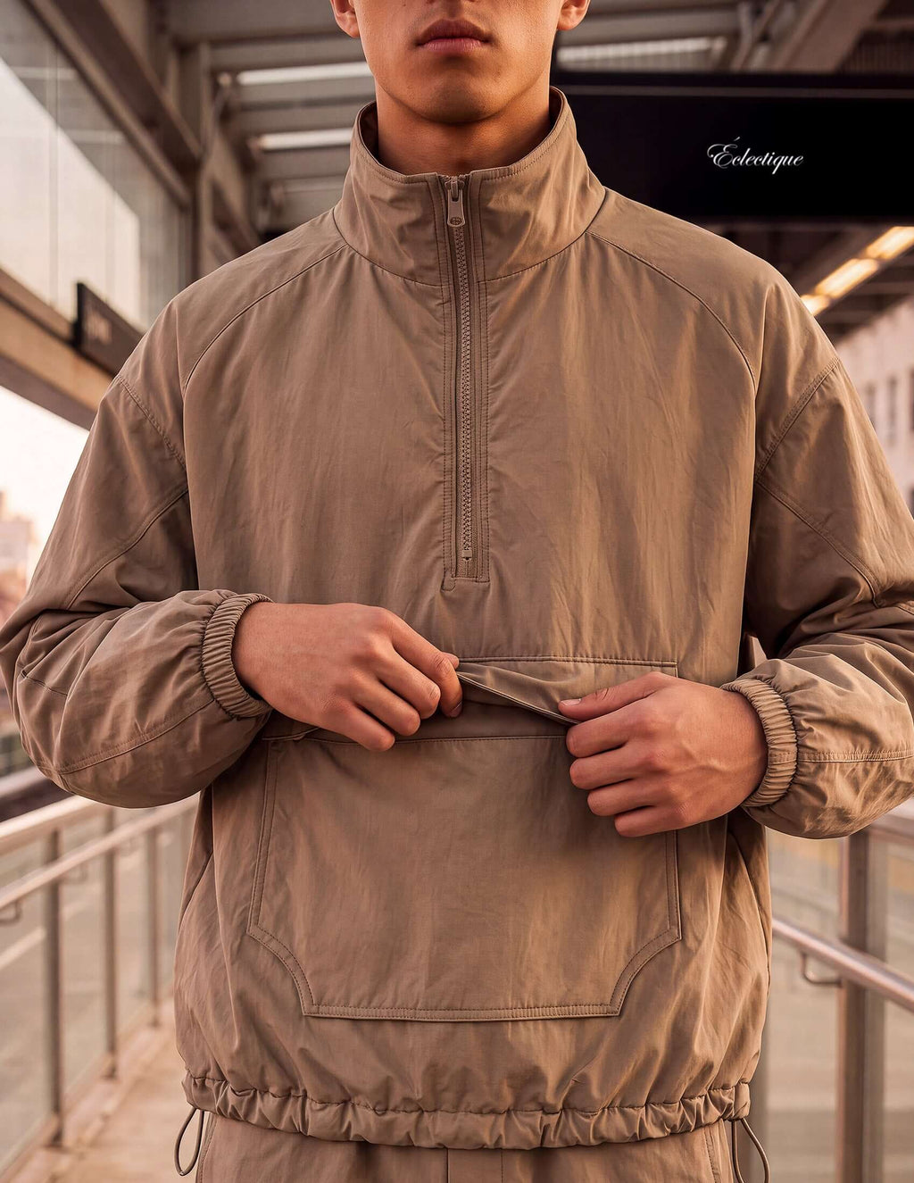 Man wearing the Waypoint Lightweight Anorak in Clay, showcasing its relaxed design and high stand collar.