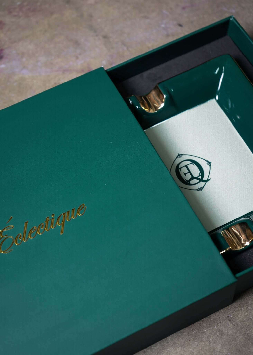 Ceramic Cigar Ashtray inside green box with gold accents and monogram logo from Éclectique.