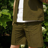 Men's casual shorts in olive green, paired with a matching shirt, perfect for stylish summer outings.