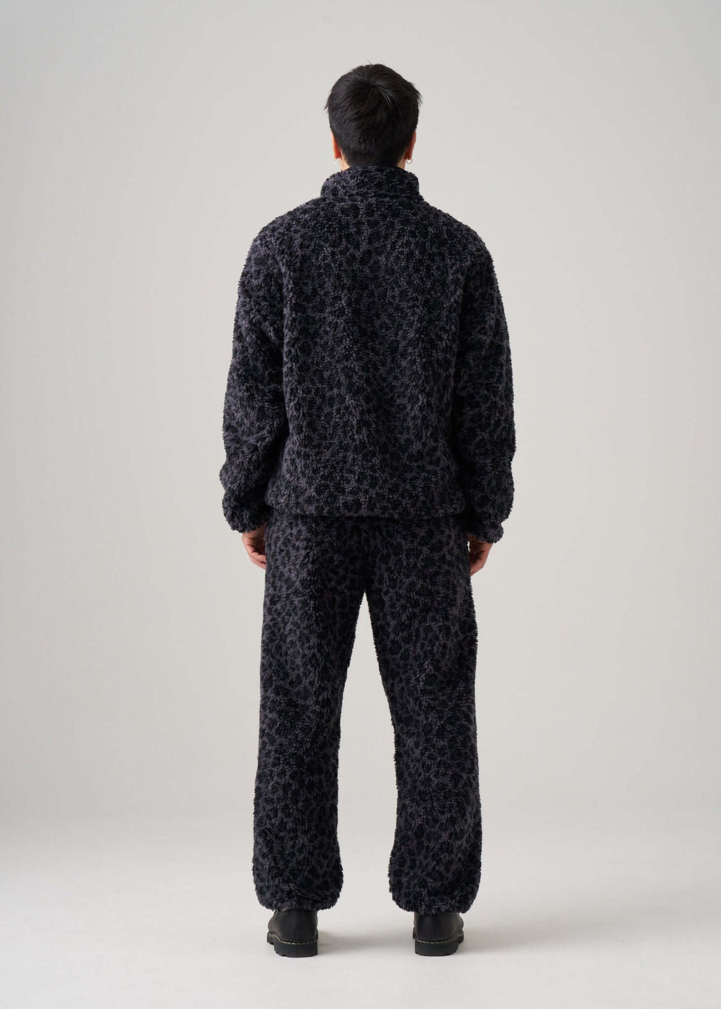 Back view of Éclectique black leopard fleece jacket worn by model