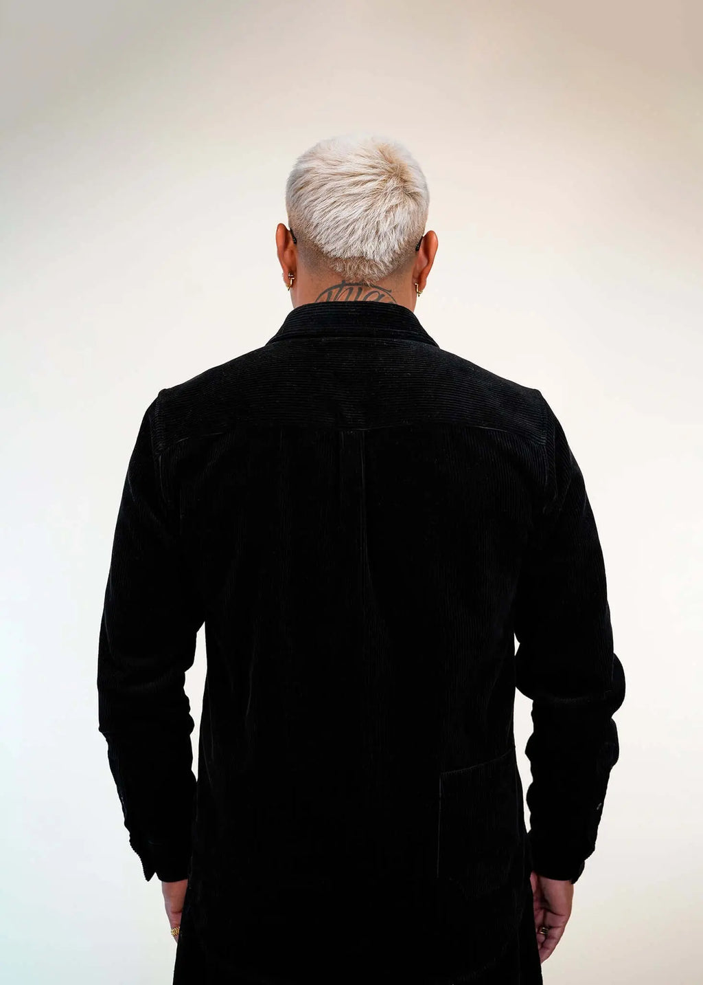 Back view of Éclectique’s corduroy button-up shirt, featuring a relaxed fit and clean silhouette with fine corduroy texture.