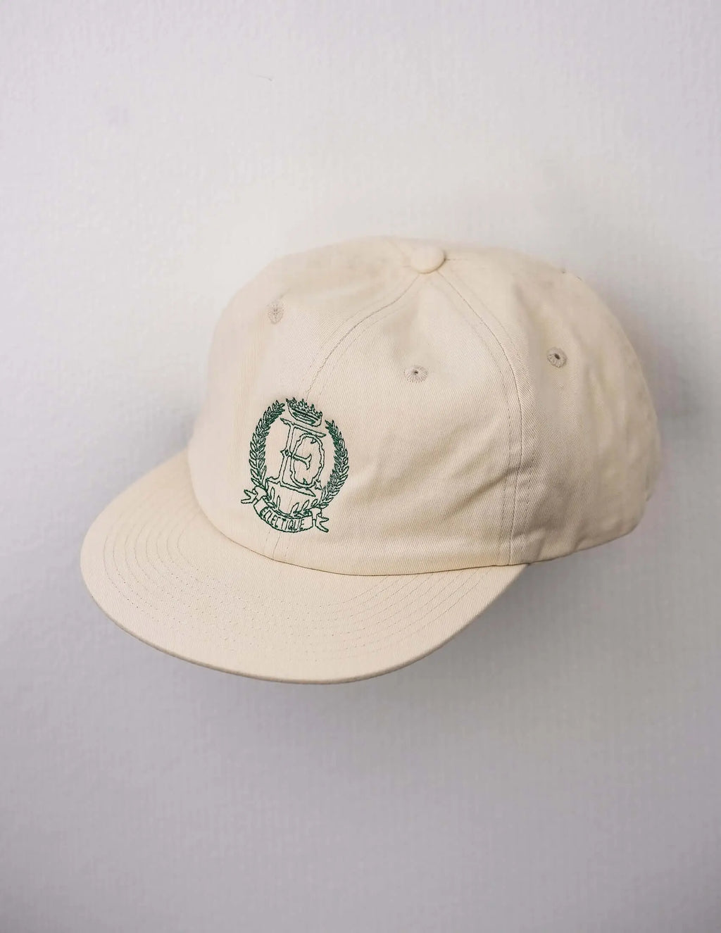Close-up of embroidery on off-white  Éclectique crest embroidered dad hat