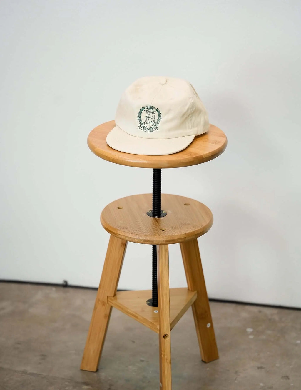 Éclectique crest embroidered dad hat with embroidered crest logo in studio setting
