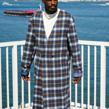 Model wearing Kanso Plaid Collarless Long Coat with a city skyline background.