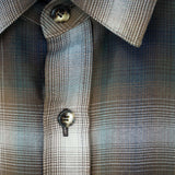 Close-up of the Mercer Plaid Cotton Button-Up Shirt showcasing its plaid pattern and button detail.