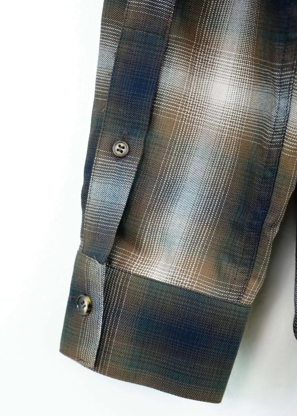 Close-up of the cuff of the Mercer Plaid Cotton Button-Up Shirt, showcasing its premium cotton fabric and plaid design.