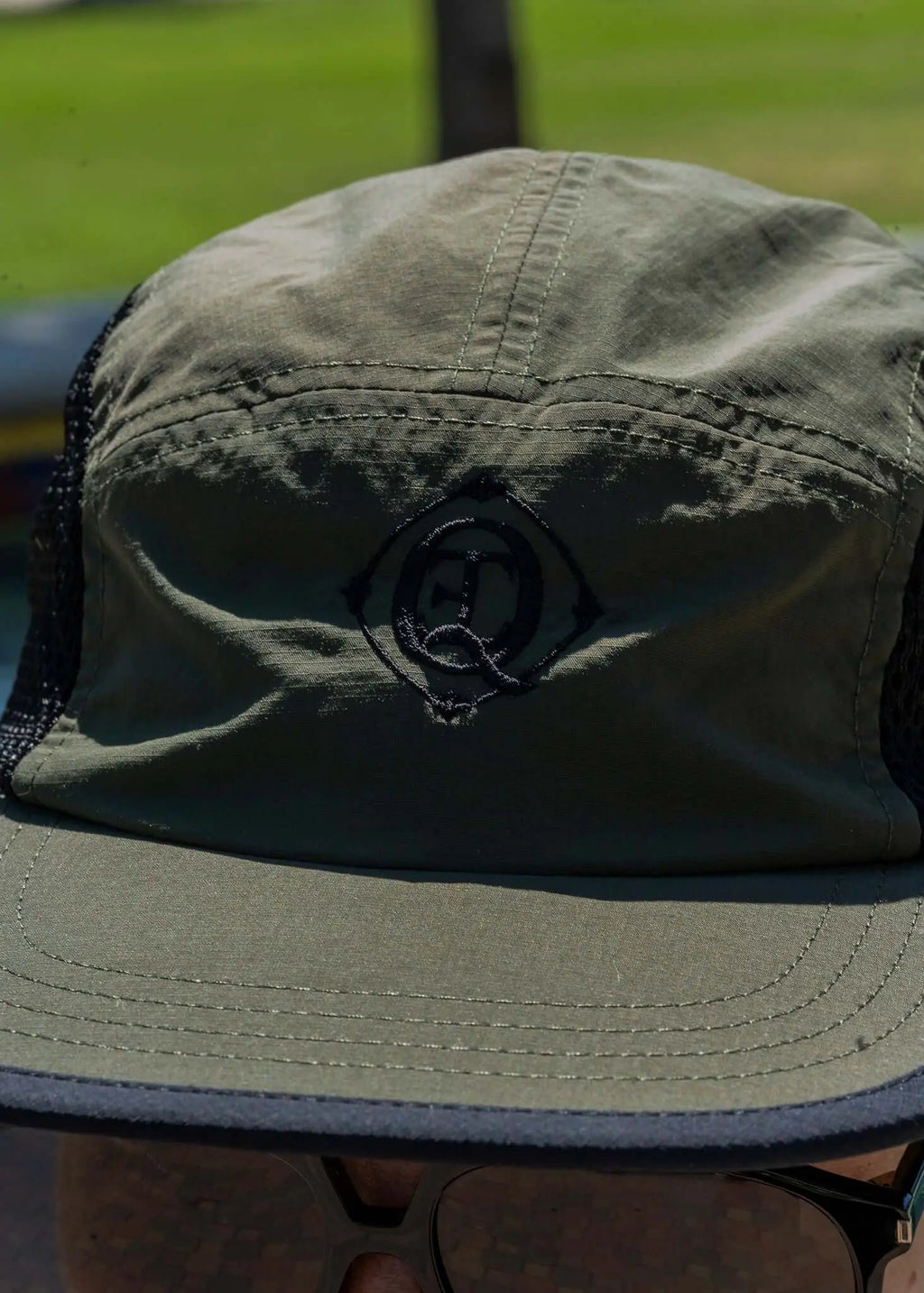 Men's Olive Performance Mesh Cap with embroidered monogram, featuring a lightweight design and breathable mesh panels.