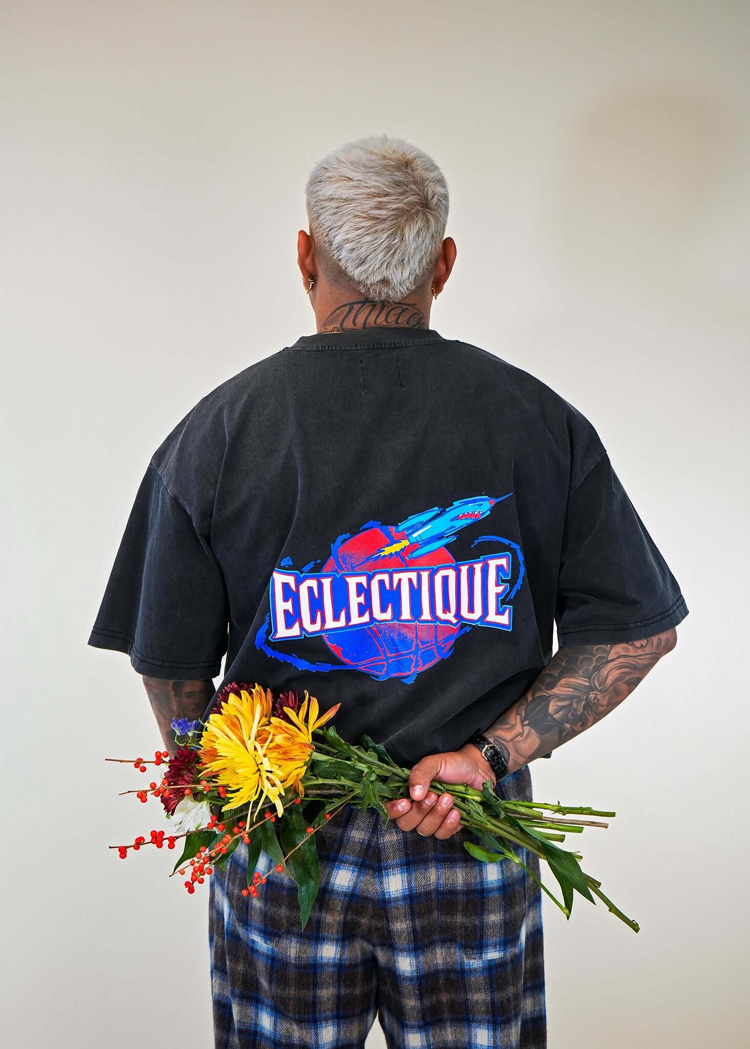 Close-up back view of Éclectique Rockets Graphic T-shirt with floral bouquet