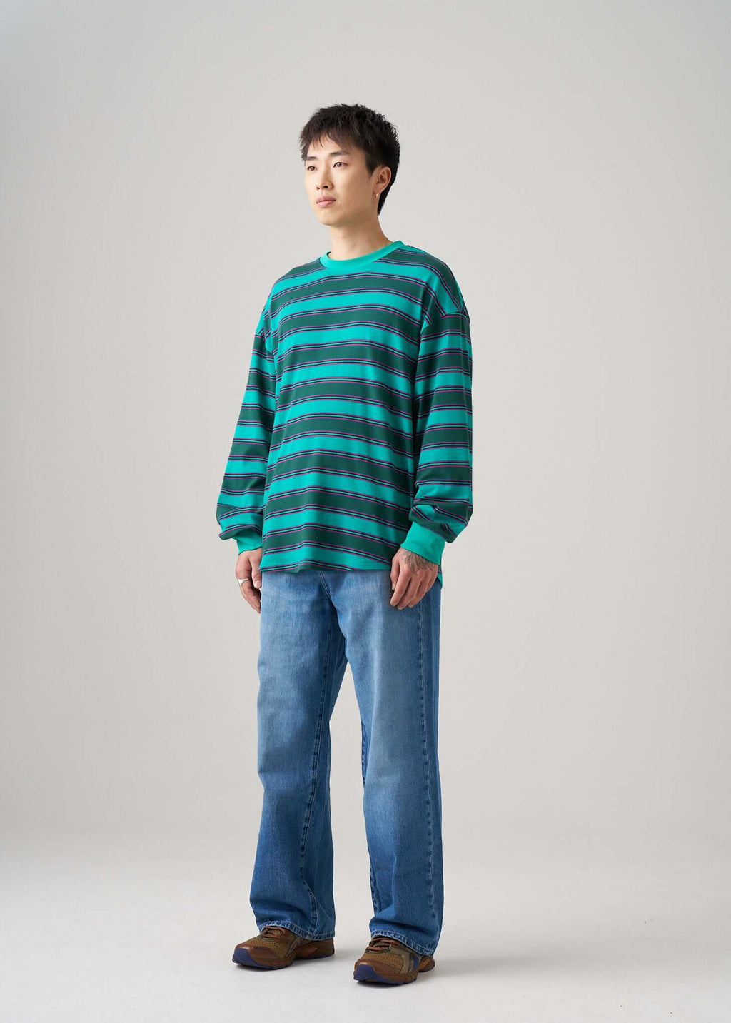 Long sleeve t-shirt in Emerald Drift pattern, worn with relaxed jeans for a casual look.