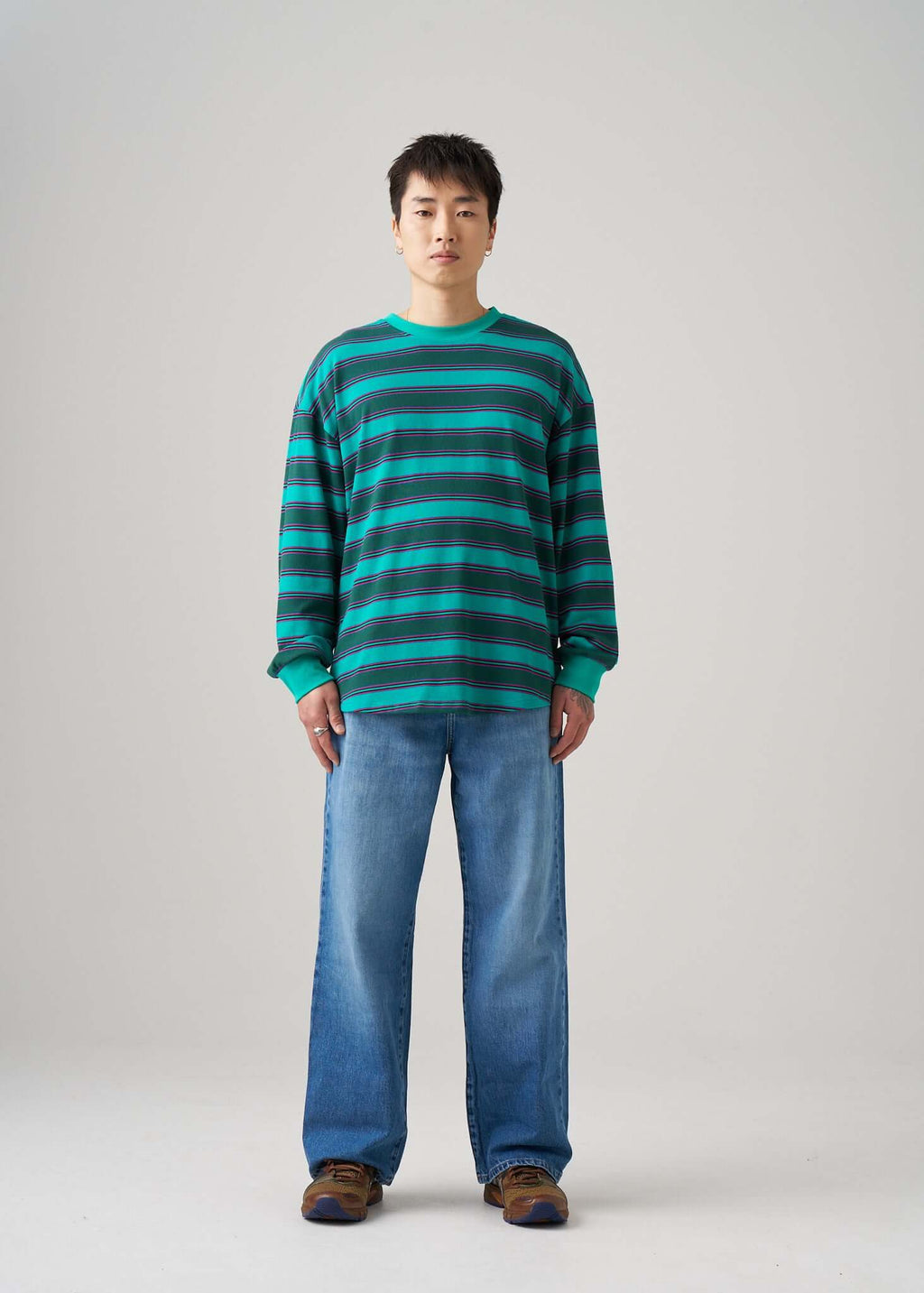 Long sleeve t-shirt in Emerald Drift pattern worn by a model with jeans and brown shoes.