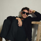 Model sitting in black Italian suede bomber jacket by Éclectique
