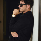 Side profile of model in Éclectique black Italian suede bomber jacket