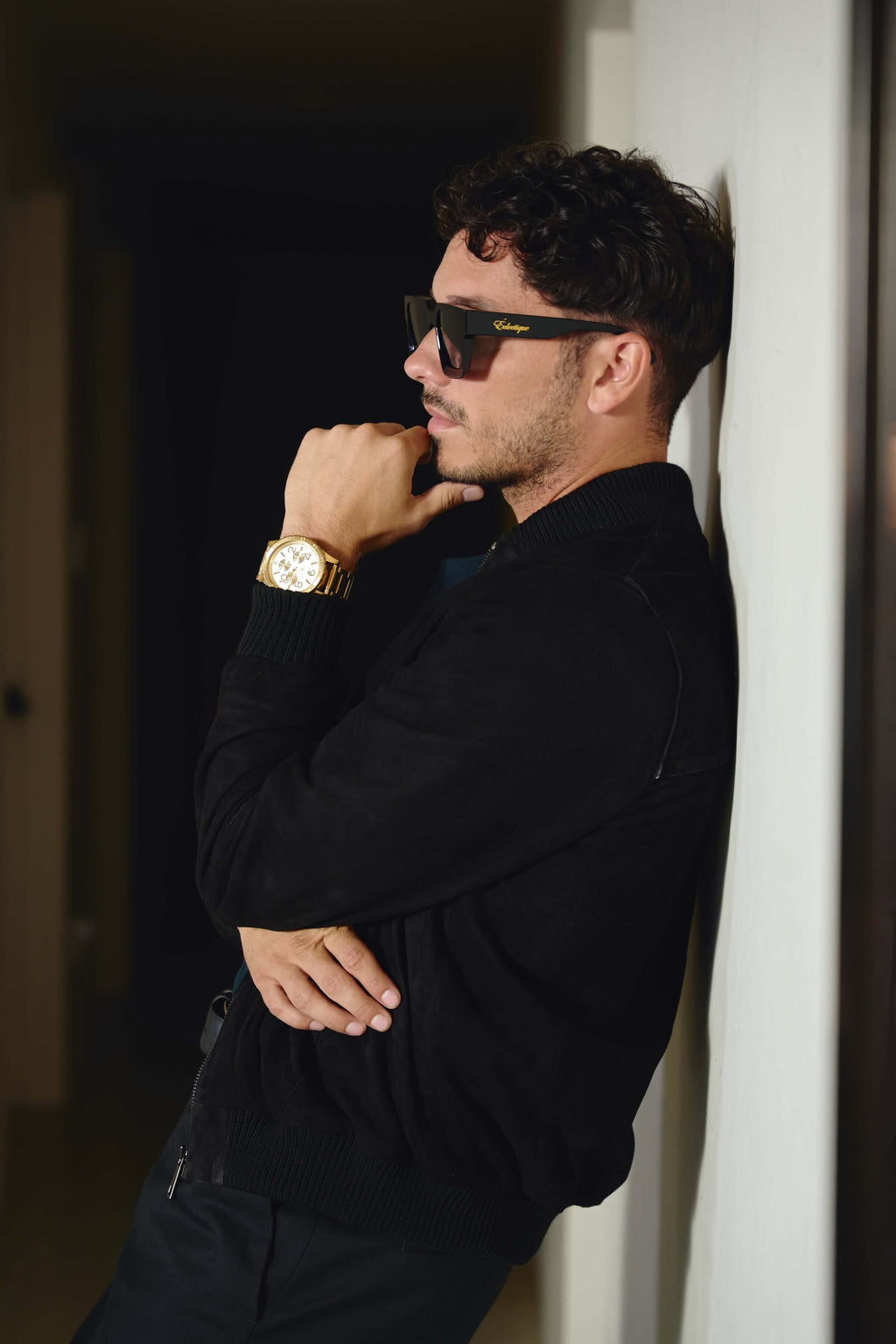 Side profile of model in Éclectique black Italian suede bomber jacket