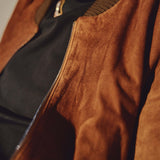Close-up of brown Italian suede bomber jacket texture and zipper by Éclectique