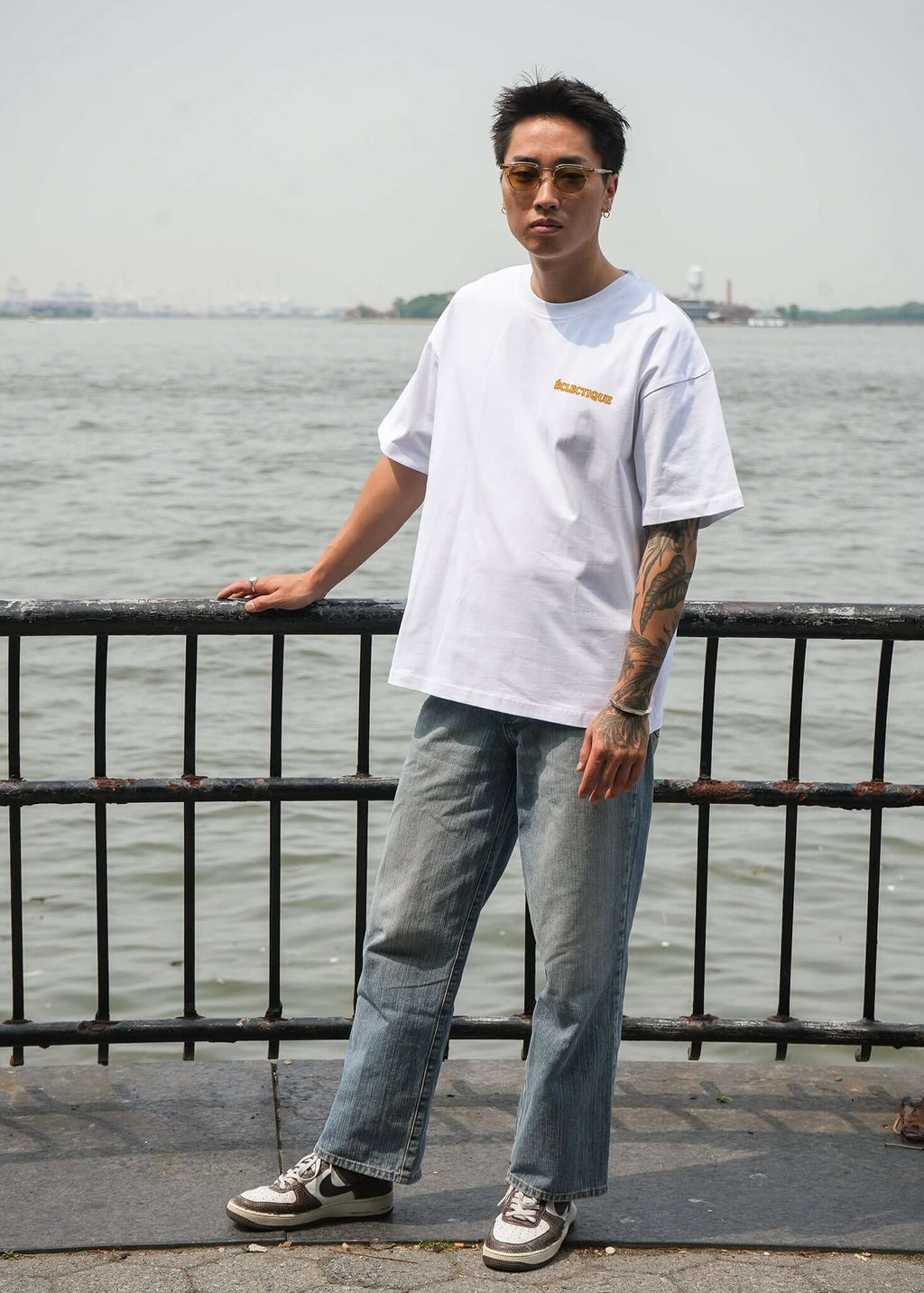 Men's Graphic T-shirt Paw Squad worn by model by water, showcasing modern fit and stylish design.