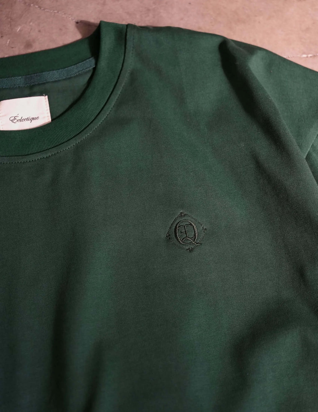 Monogram embroidered cotton t-shirt in emerald green showing embroidered logo on left chest.