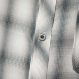 Close-up of the Monotone Plaid Button-Up Shirt showcasing the intricate tonal pattern and button detail.