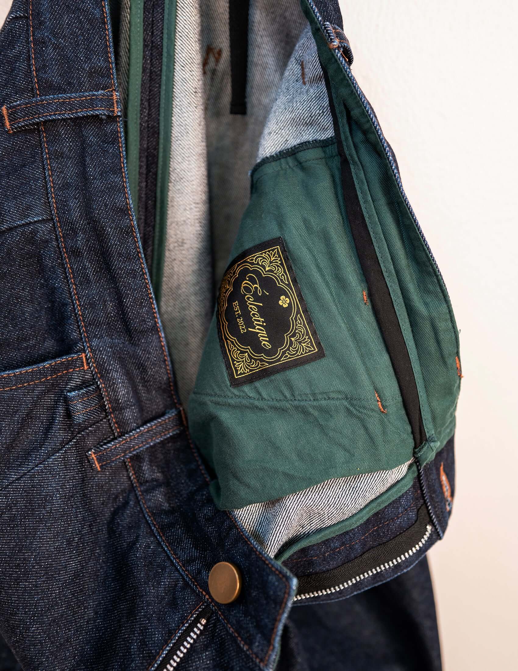 Close-up of Éclectique Japanese Denim Pleated Jeans showcasing the interior design and branding.