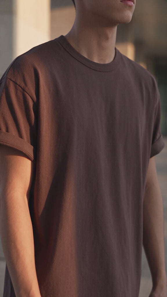 men's chocolate brown cotton t-shirt essential worn by model doing a slight turn. 