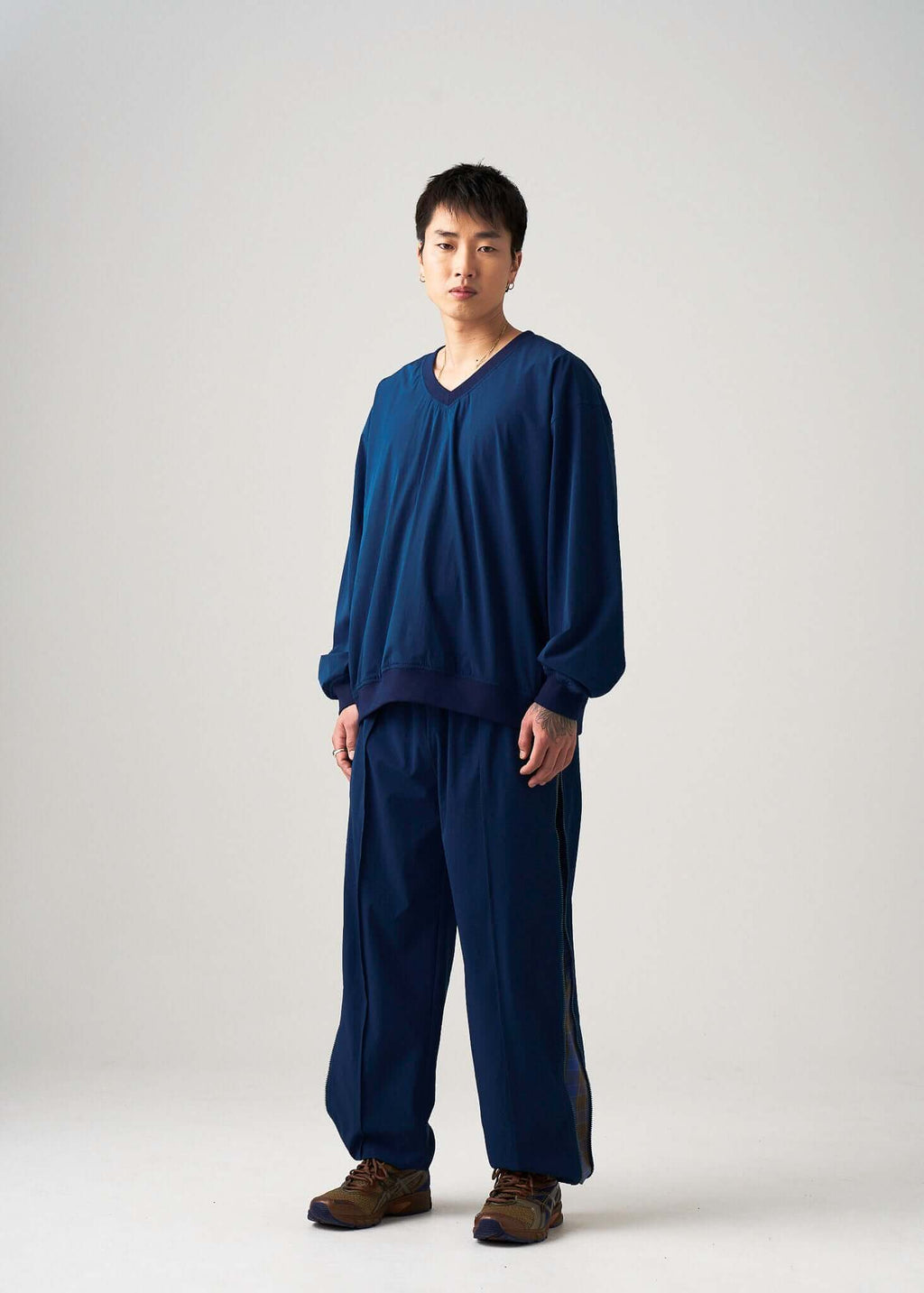 Reversible windbreaker jacket shown on model from a slight angle, navy lightweight design