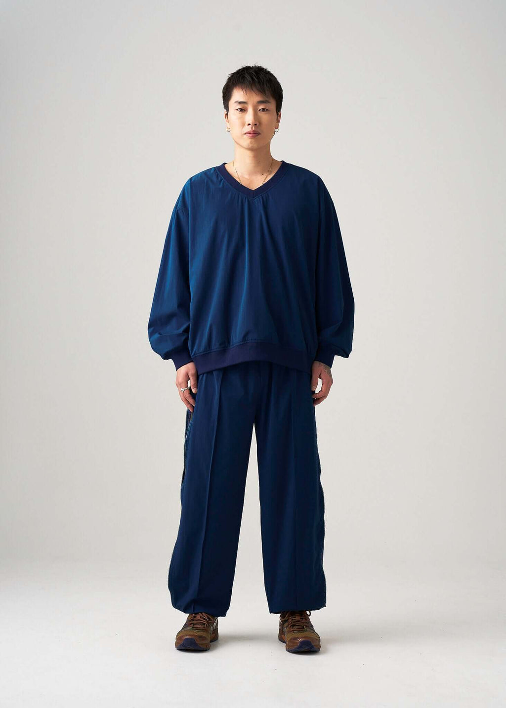 Model wearing the reversible windbreaker jacket in navy lightweight fabric, front view
