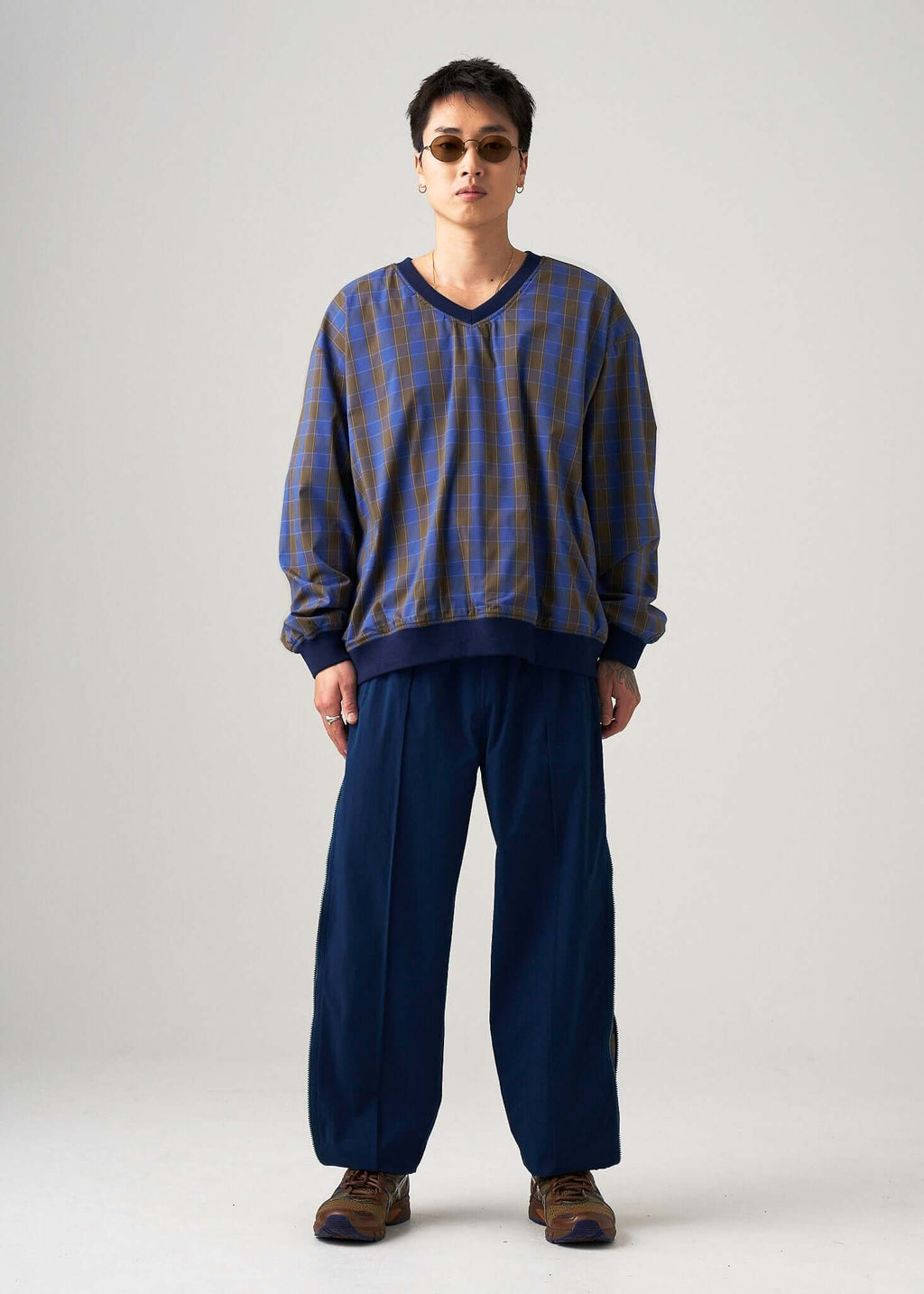 Model styling the reversible windbreaker jacket with a relaxed urban fit, angled front view