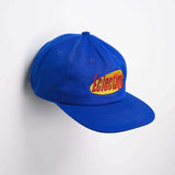 Seinfeld Vintage logo hat in royal blue with embroidered Éclectique logo on the front, showcasing a vintage style.